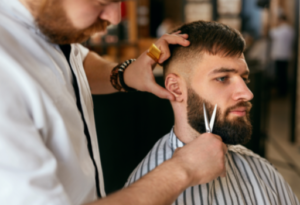 Man clipping clients beard