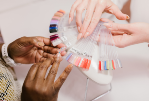 woman choosing nail colour in nail salon