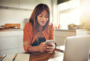 Women looking at phone in her hand smiling