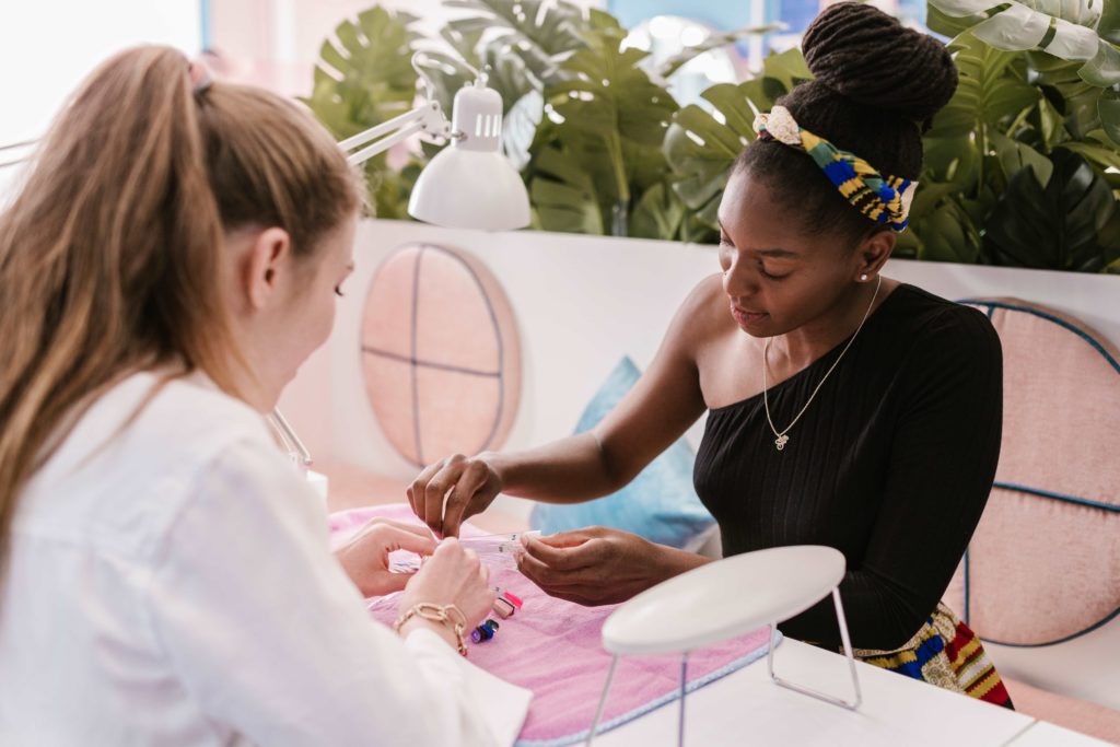 Girl having nails done in unique salon