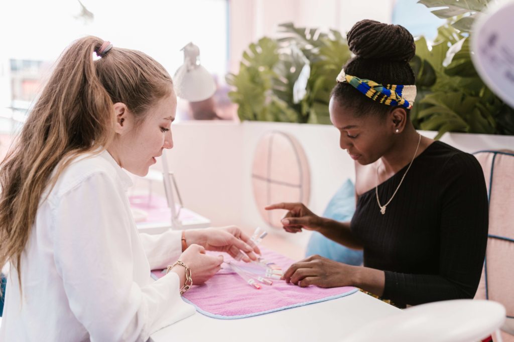 beauty salon worker and nail client